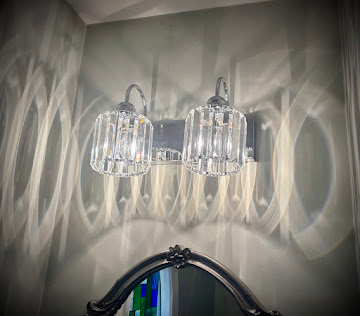 Crystal vanity light fixture installed in a Winchester bathroom