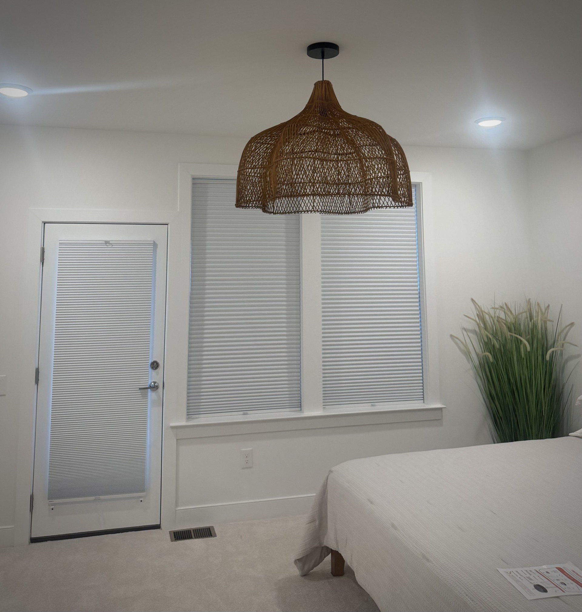 Woven pendant light installed in a Boyce bedroom